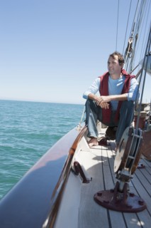 Caucasian man relaxing on sailboat
