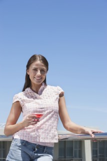 Caucasian woman drinking cocktail outdoors
