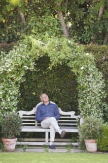 Senior Caucasian man sitting on garden bench