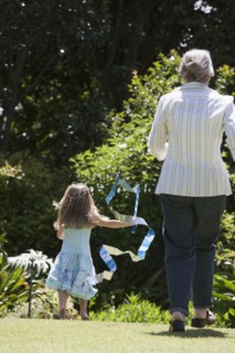 Senior Caucasian woman and granddaughter playing outdoors
