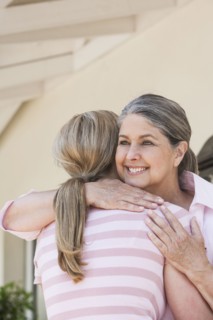 Caucasian mother and daughter hugging