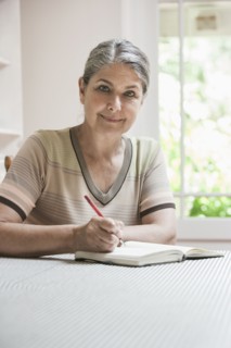 Caucasian woman writing in journal