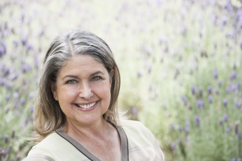 Caucasian woman smiling in lavender field