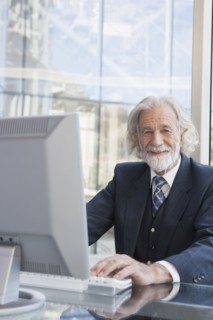 Senior Caucasian businessman working at desk