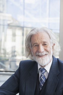Senior Caucasian businessman smiling in office