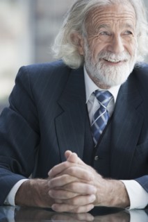 Senior Caucasian businessman smiling in office