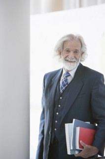 Senior Caucasian businessman carrying books