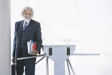 Senior Caucasian businessman carrying books