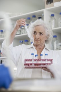 Senior Caucasian scientist examining samples in lab