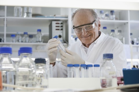 Senior Caucasian scientist examining samples in lab