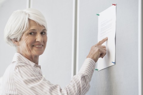 Senior Caucasian woman reading sign