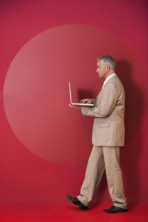 Businessman walking with laptop