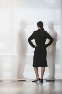 Businesswoman watching colleagues shake hands behind curtain