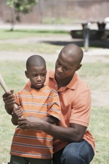 Father teaching son to play baseball