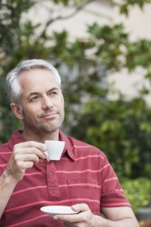 Man drinking espresso outdoors