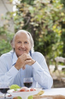 Man eating at table outdoors