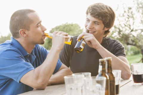 Men drinking beer together outdoors