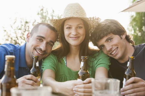 Friends drinking beer together outdoors