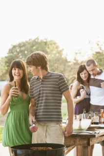 Friends having barbecue outdoors