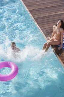 Couple splashing in swimming pool