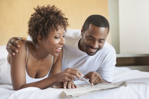 African American couple reading in bed