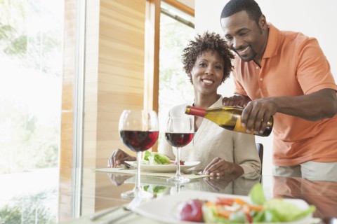 African American couple having wine at dinner