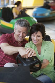 Caucasian couple driving bumper car
