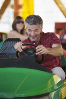 Caucasian man driving bumper car