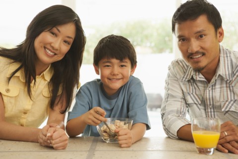 Family smiling together at breakfast table