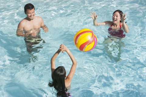 Family playing together in swimming pool