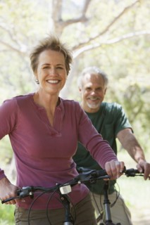 Senior Caucasian couple riding bicycles on rural path