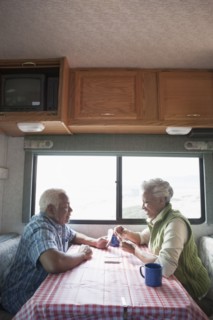 Mixed race Senior couple having coffee in RV