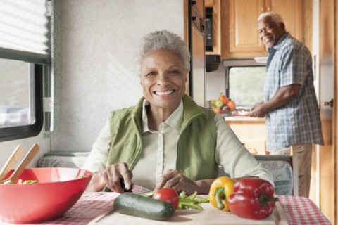 Mixed race Senior couple cooking in RV