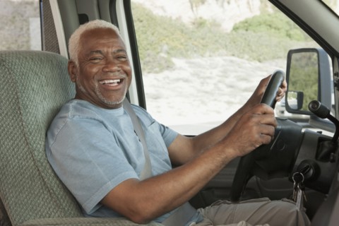 Mixed race Senior man driving RV
