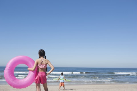 Hispanic children playing on beach