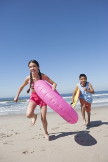 Hispanic children playing on beach