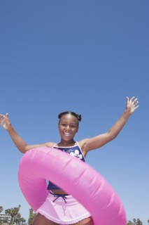 African American girl playing with inner tube