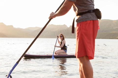 Couple on paddleboards in river
