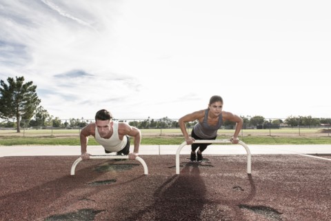 Couple doing push-ups outdoors