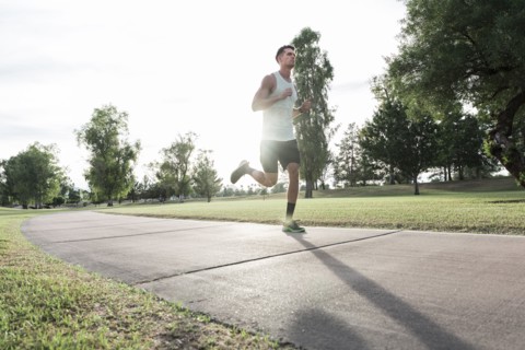 Caucasian man running on path in park