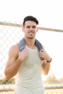 Portrait of Caucasian man resting with towel outdoors