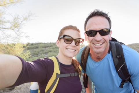 Hikers posing for cell phone selfie