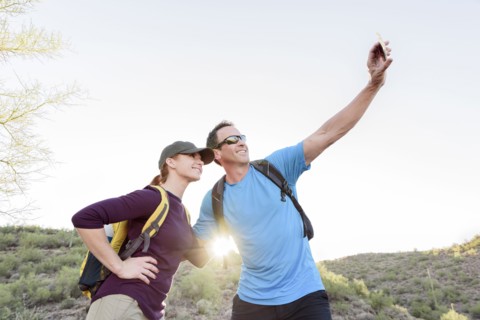 Hikers posing for cell phone selfie