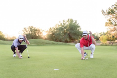 Golfers aiming on golf course