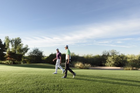 Friends walking on golf course