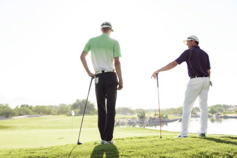 Friends talking on golf course