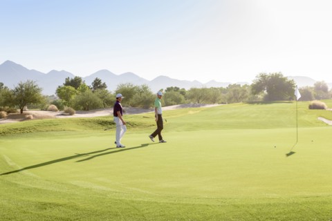 Friends walking on golf course
