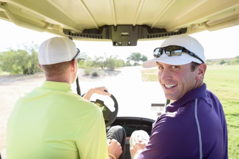 Friends driving on golf course