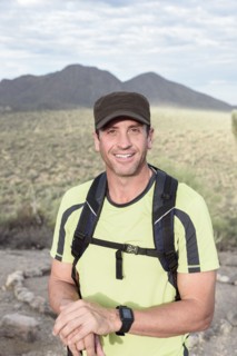 Portrait of smiling Hispanic man hiking in desert
