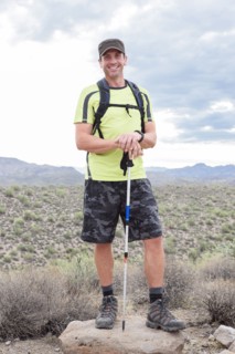 Portrait of smiling Hispanic man hiking in desert